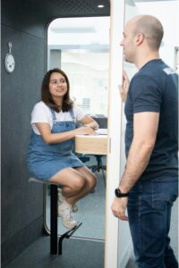Image of two work colleagues in a blog on reducing AI-human bottlenecks in the workplace